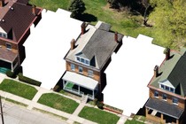 An illustration of suburban homes in a row, with two of the houses missing.