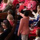 A Representative holds up a sign that reads "SAVE MEDICAID" near a group of congresspeople wearing pink