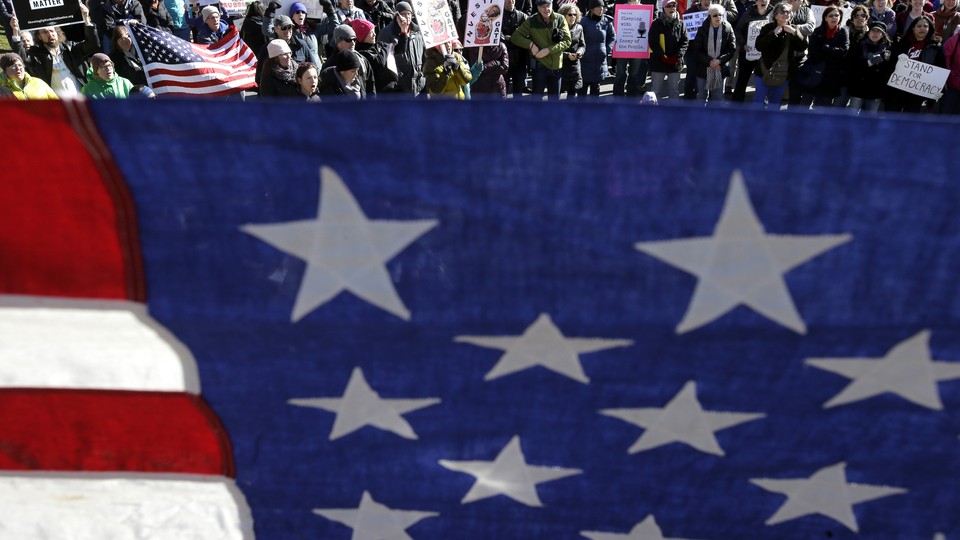 Protesters at a demonstration called for an investigation into the possible involvement of Russian officials in the 2016 campaign.