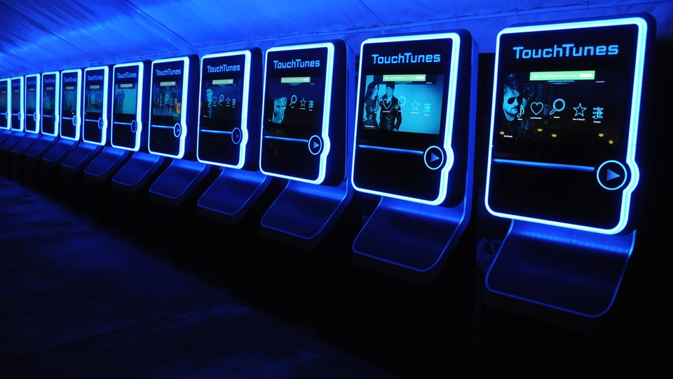 A row of TouchTunes digital jukeboxes