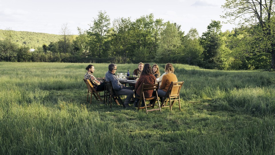 People sitting a table in a park