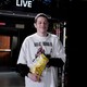 Pete Davidson holding a bag of chips in the SNL studio