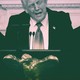 Donald Trump throws up his arms in front of a podium