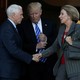 Vice President-elect Mike Pence shakes Education Secretary Appointee Betsy DeVos's hand. President-elect Donald Trump stand between them.