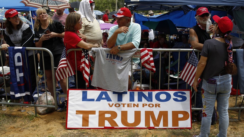 A Latinos Vote For Trump sign outside of a Trump rally.