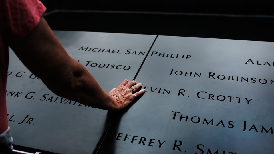 A man reflects on the names inscribed at the September 11 memorial in Lower Manhattan.
