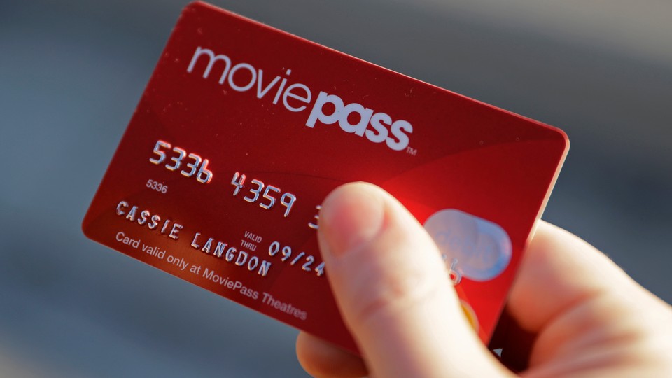 A hand holding a MoviePass card