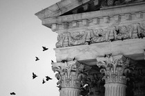 A black-and-white photo of the outside of the Supreme Court building