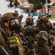 A photo of military personnel deployed to a scene of civil unrest