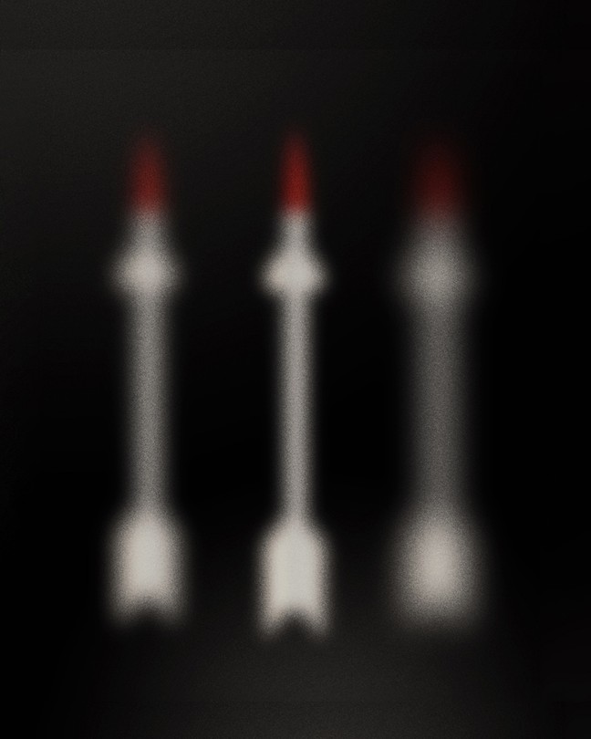 Illustration of three out-of-focus fuzzy red-tipped white arrows on black background
