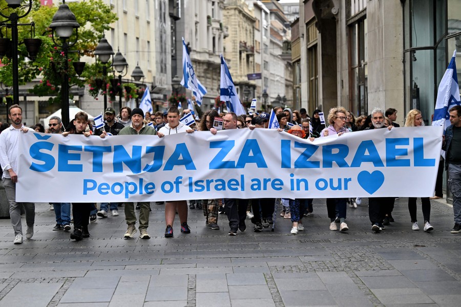 A protest group carries a banner reading "People of Israel are in our heart"