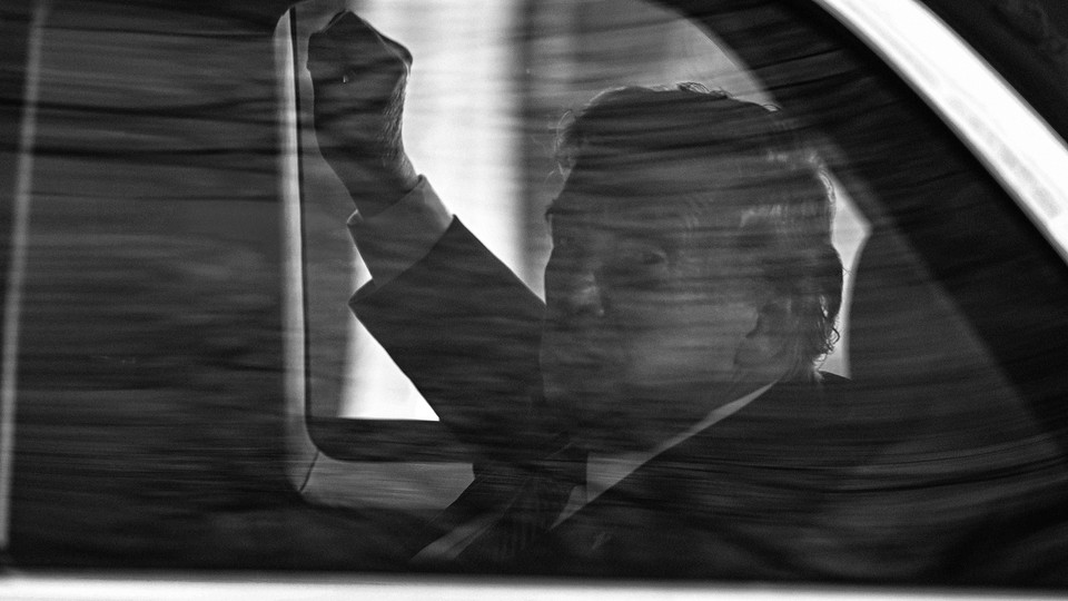 Trump in black and white through car window