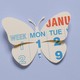 A paper cutout of a calendar in the shape of a butterfly