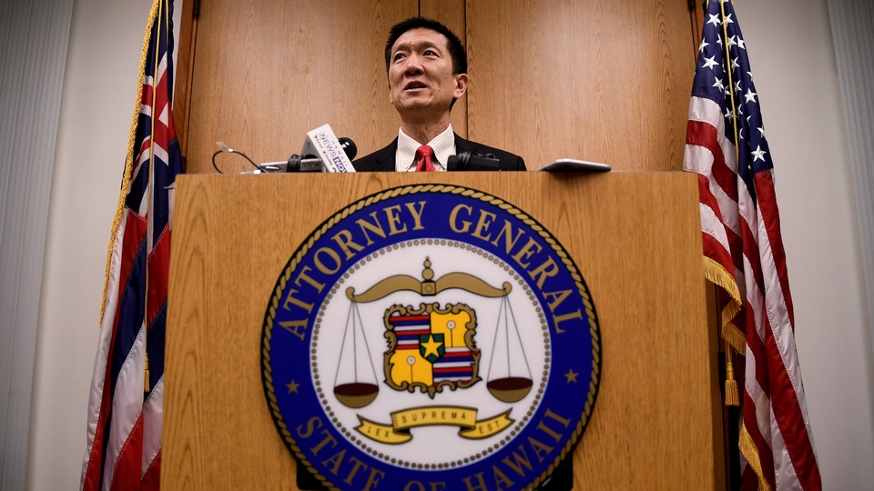Hawaii Attorney General Douglas Chin speaks at a press conference after filing an amended lawsuit against Donald Trump's travel ban on March 9, 2017.