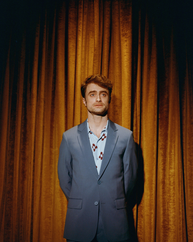 photo of Radcliffe standing in front of theater curtain