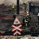 Fire and rescue workers attend to a building hit by a missile in Kyiv.