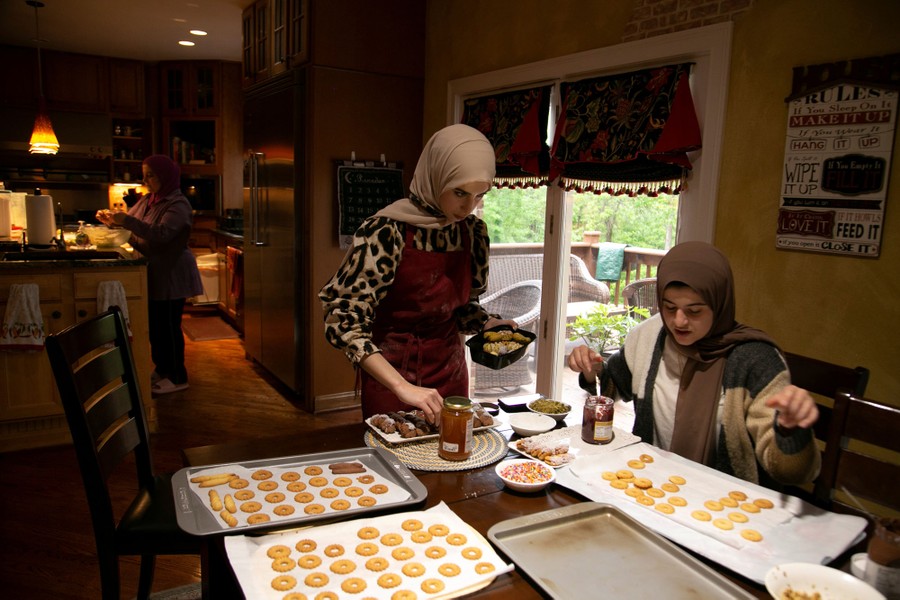 People prepare sweets in a kitchen at home.