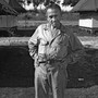 William L. "Atomic Bill" Laurence standing with hands on hips at Tinian Island in the Pacific, the launching point for the atomic bomb attacks against Hiroshima and Nagasaki