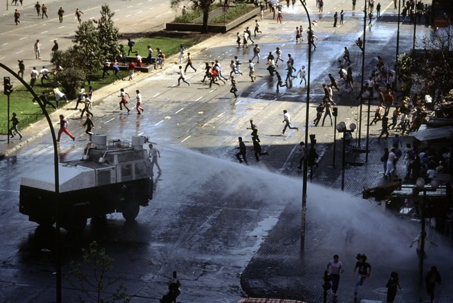 Water cannons shooting at people who are celebrating victory for the “No” campaign in Chile in 1988. 