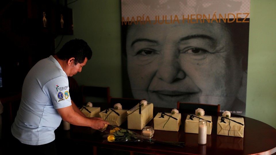 The urns of six victims of the El Mozote massacre are seen during a wake in San Salvador, El Salvador, on December 7, 2018.