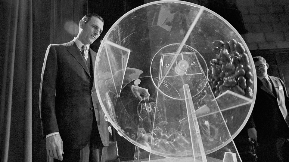 Draft Director Curtis W. Tarr spins a Plexiglas drum in 1972 as the fourth annual Selective Service lottery begins.