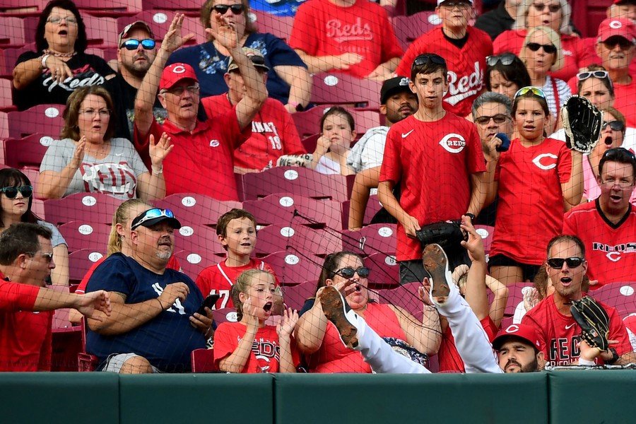 A baseball player falls into the stands during a game in Cincinnati.