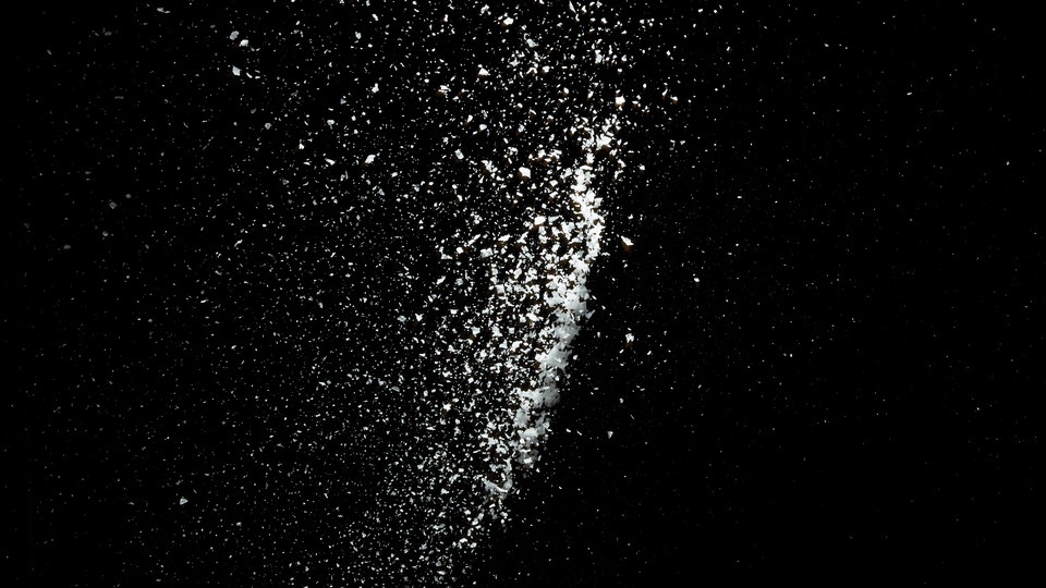 Salt sprinkled against a black background