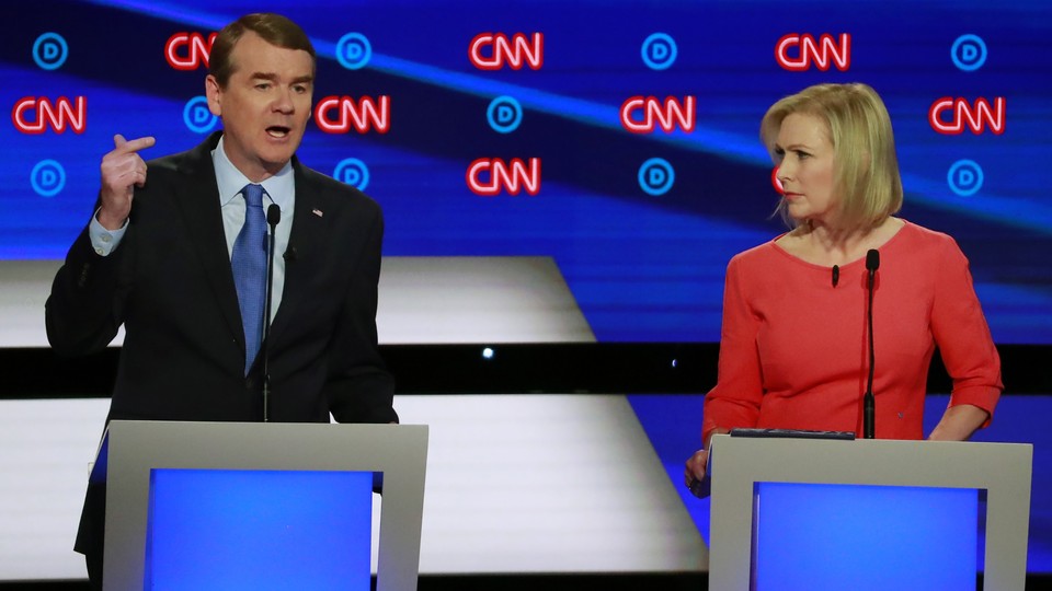 Candidates U.S. Senator Kirsten Gillibrand (right) listens as U.S. Senator Michael Bennet speaks on the second night of the second 2020 Democratic U.S. presidential debate in Detroit, Michigan.