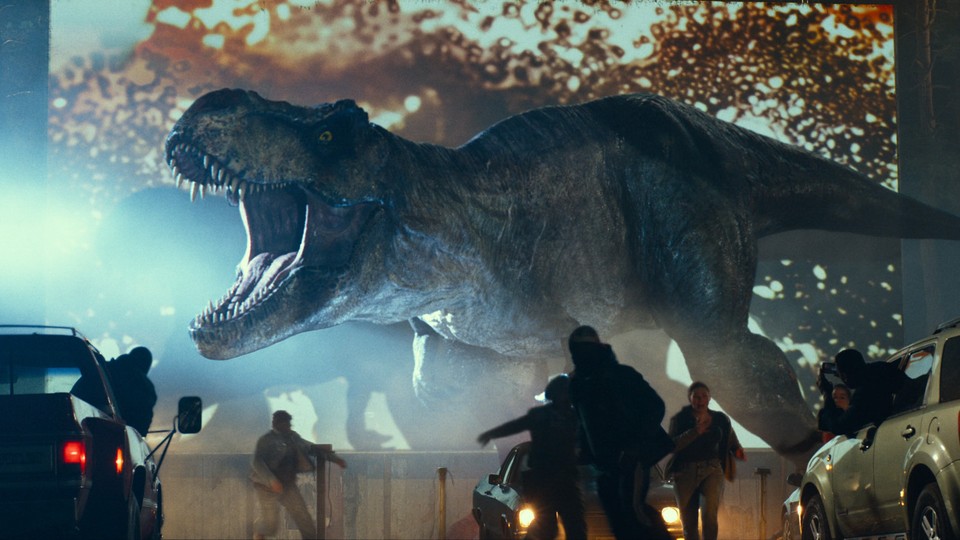 A Tyrannosaurus rex rampaging through a parking lot in "Jurassic World: Dominion"