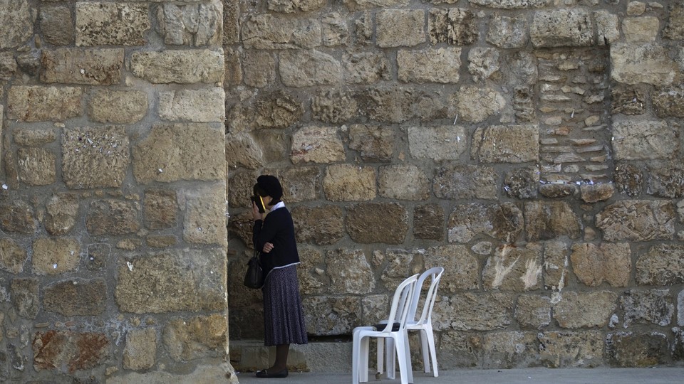 A Jewish woman prays at the Western Wall in Jerusalem's Old City on May 1, 2014. 
