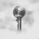 A grey key floats in the white and grey fog