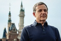 Bob Iger standing in front of a Disney castle