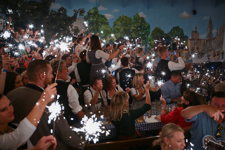 People light sparklers to celebrate at the end of Oktoberfest.