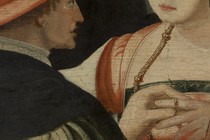 A man placing a wedding ring on a woman’s finger