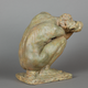 photo of sculpture of crouching woman seen from the back