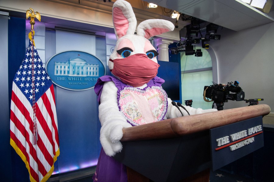 The masked Easter Bunny appears at a podium.