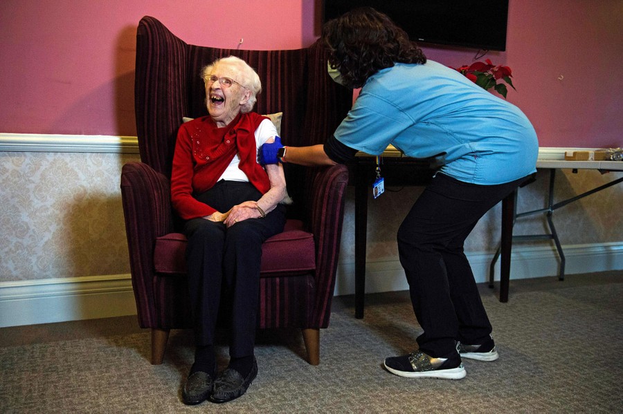 A woman receives a vaccine shot.