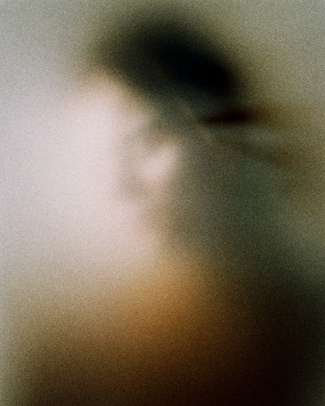 a foggy image of a woman in a soft glow of light