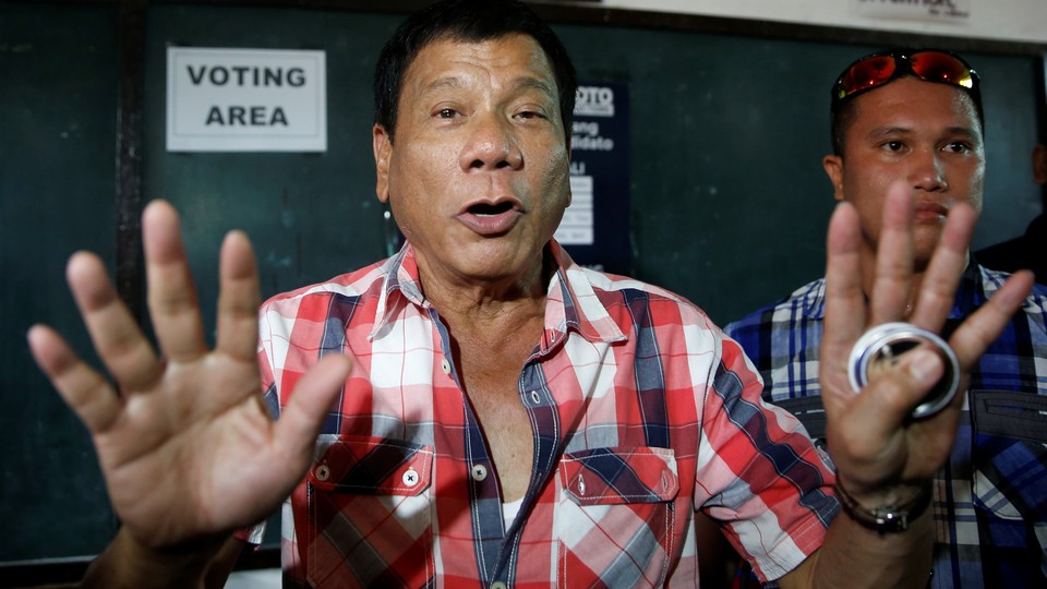 Presidential candidate Rodrigo "Digong" Duterte talks to the media before casting his vote at a polling precinct for national elections at Daniel Aguinaldo National High School in Davao city in southern Philippines, May 9, 2016.