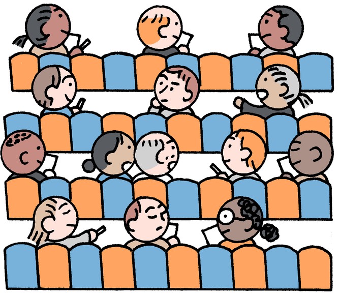 people in a theater seats with notebooks