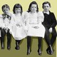 An photo of six children sitting in order of height