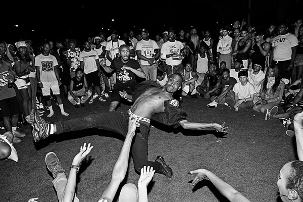 Monochrome, crowd of people watching a vogue performance in a public space