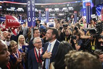 J. D. Vance standing next to the "Ohio" sign and surrounded by a crowd of Trump supporters and press at the Republication National Convention