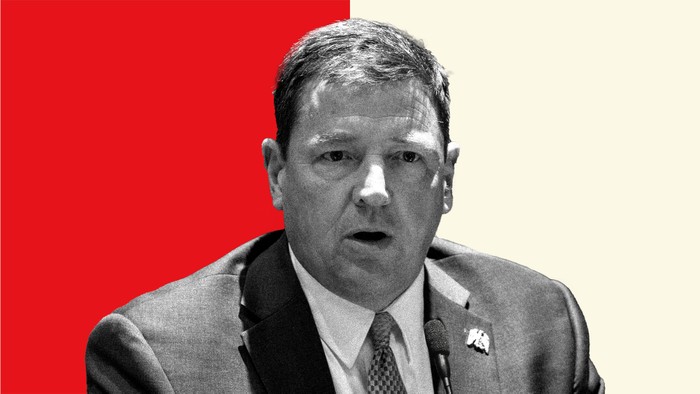 Ed Martin in front of a split-screen beige and red background