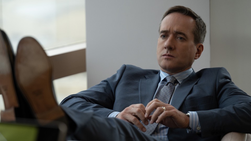 Tom Wambsgans from "Succession" sits in a chair, looking upset.