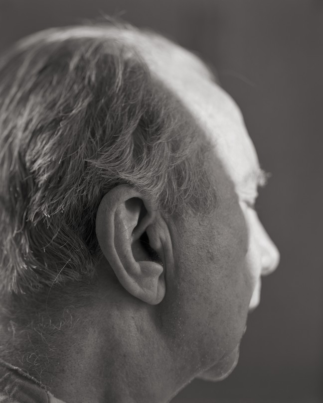 An older man's profile from behind