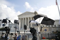 Television camera crews wait outside the Supreme Court