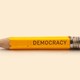 An illustration of a pencil that is engraved with the word "democracy"
