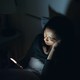 Woman using phone in bed