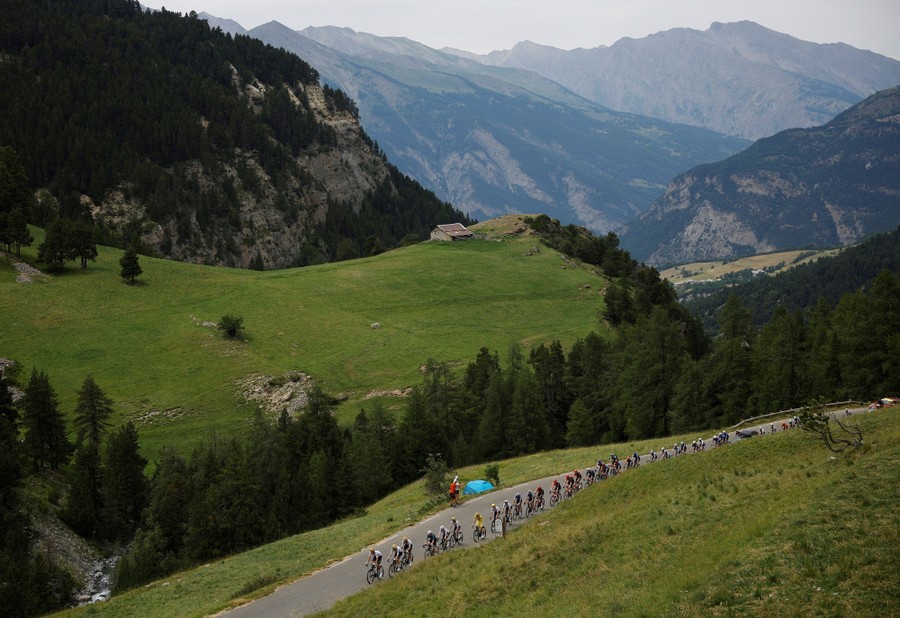Cyclists pass through a mountain road during the Tour de France